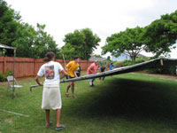 Putting up the tent in the backyard for the pre party