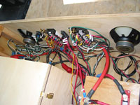 Behind the scenes wiring of the circuit breaker panel and speakers