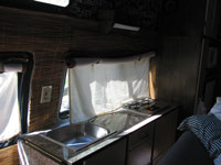 The curtain and bamboo wall lining in the kitchen area